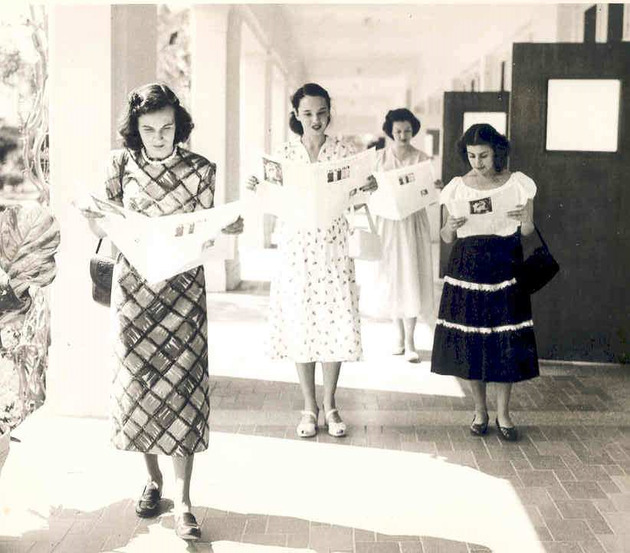 Students reading student newspaper Angelicus